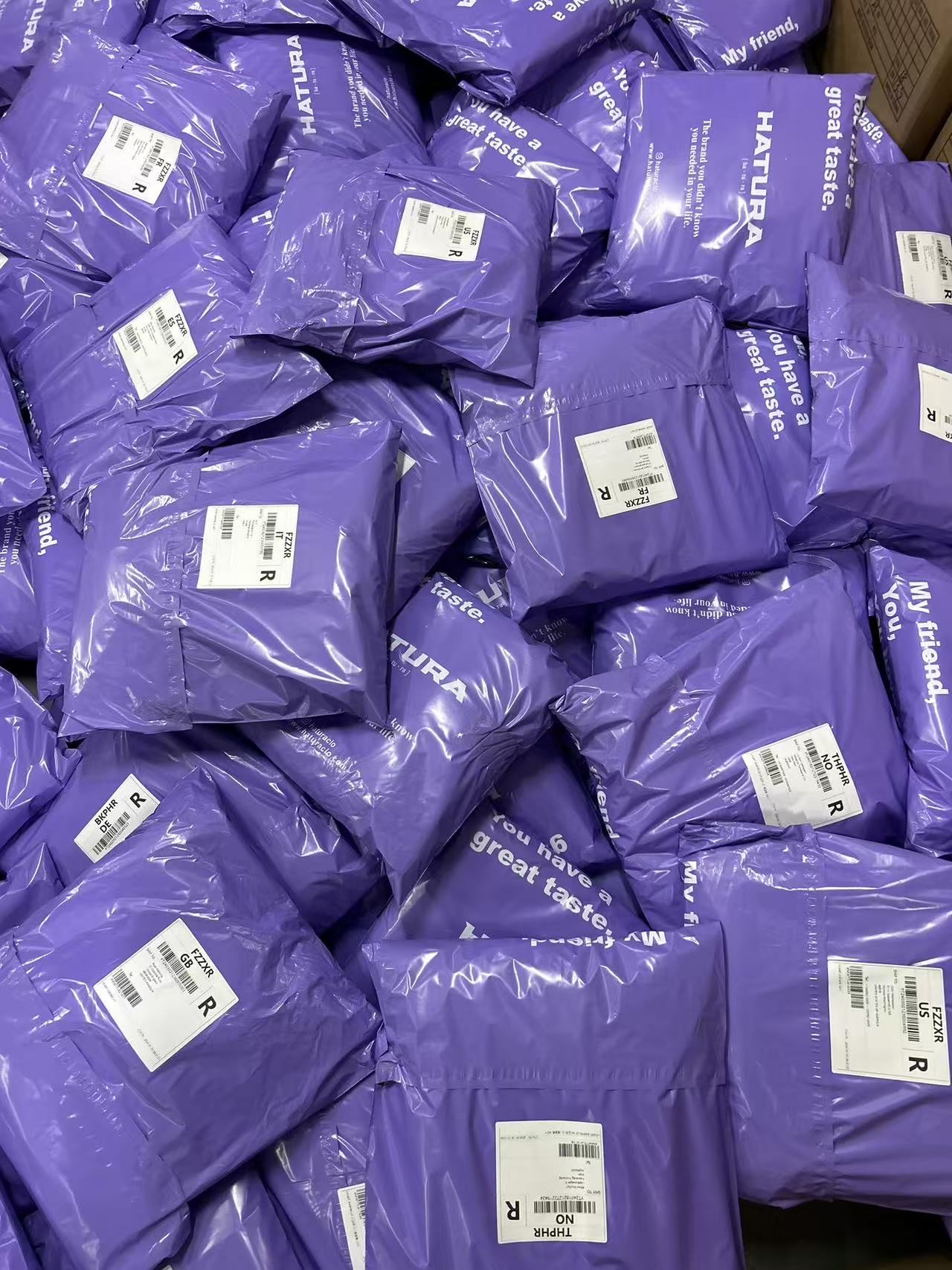 Purple small parcels with shipping labels attached